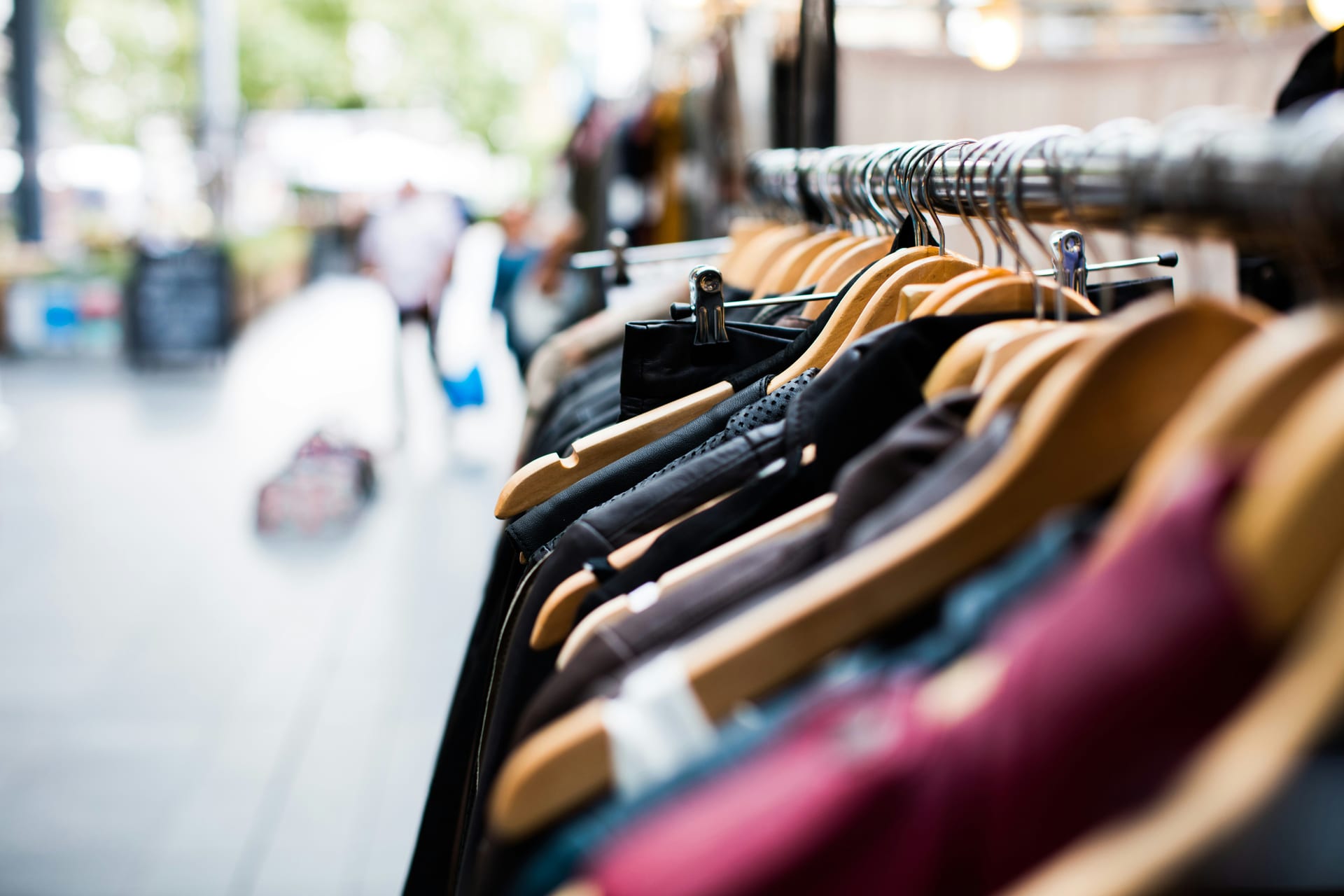 A clean retail floor with neatly arranged clothing rails