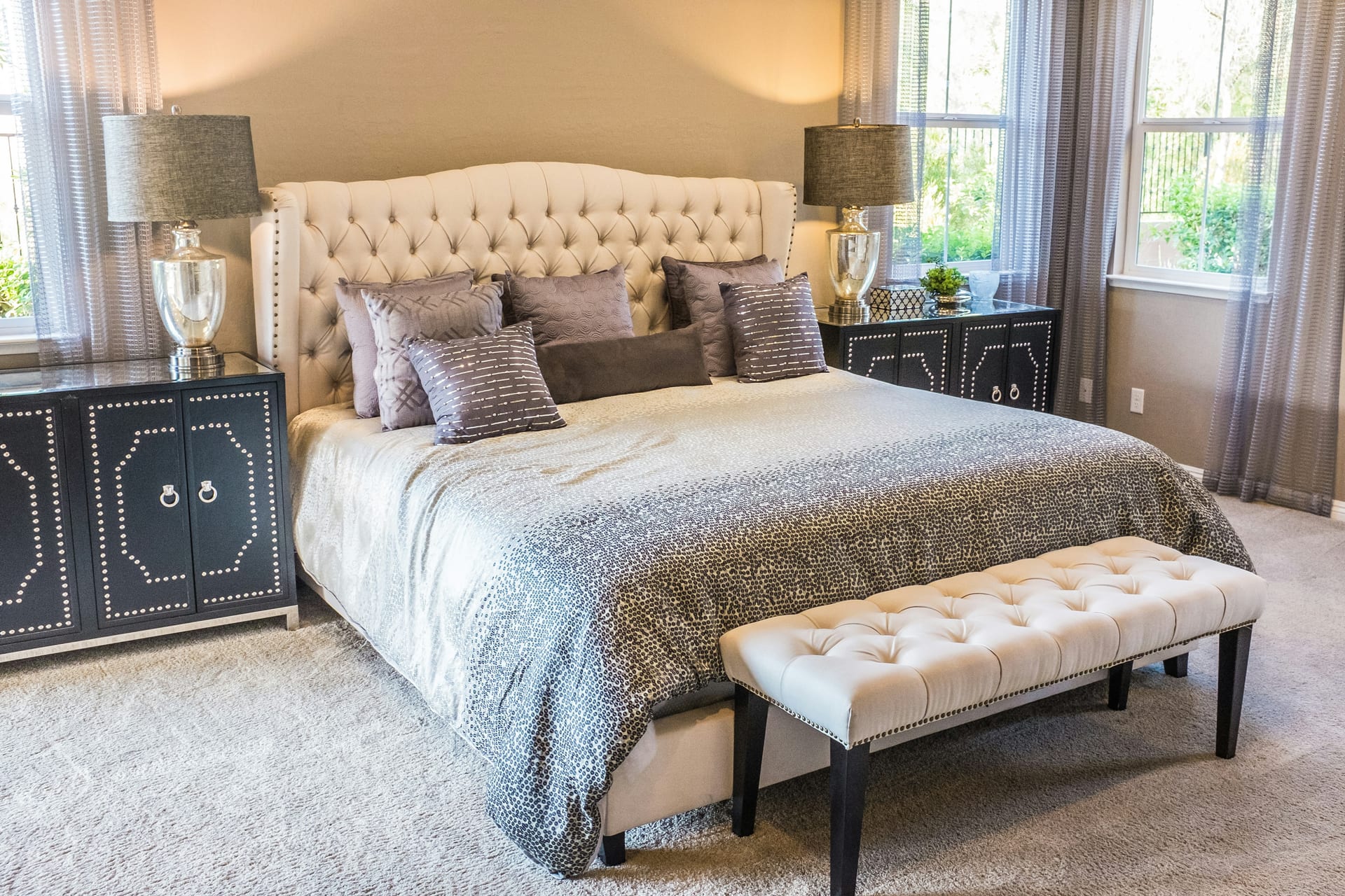 A guest bedroom made up with fresh linen and cushions, ready for the next arrival