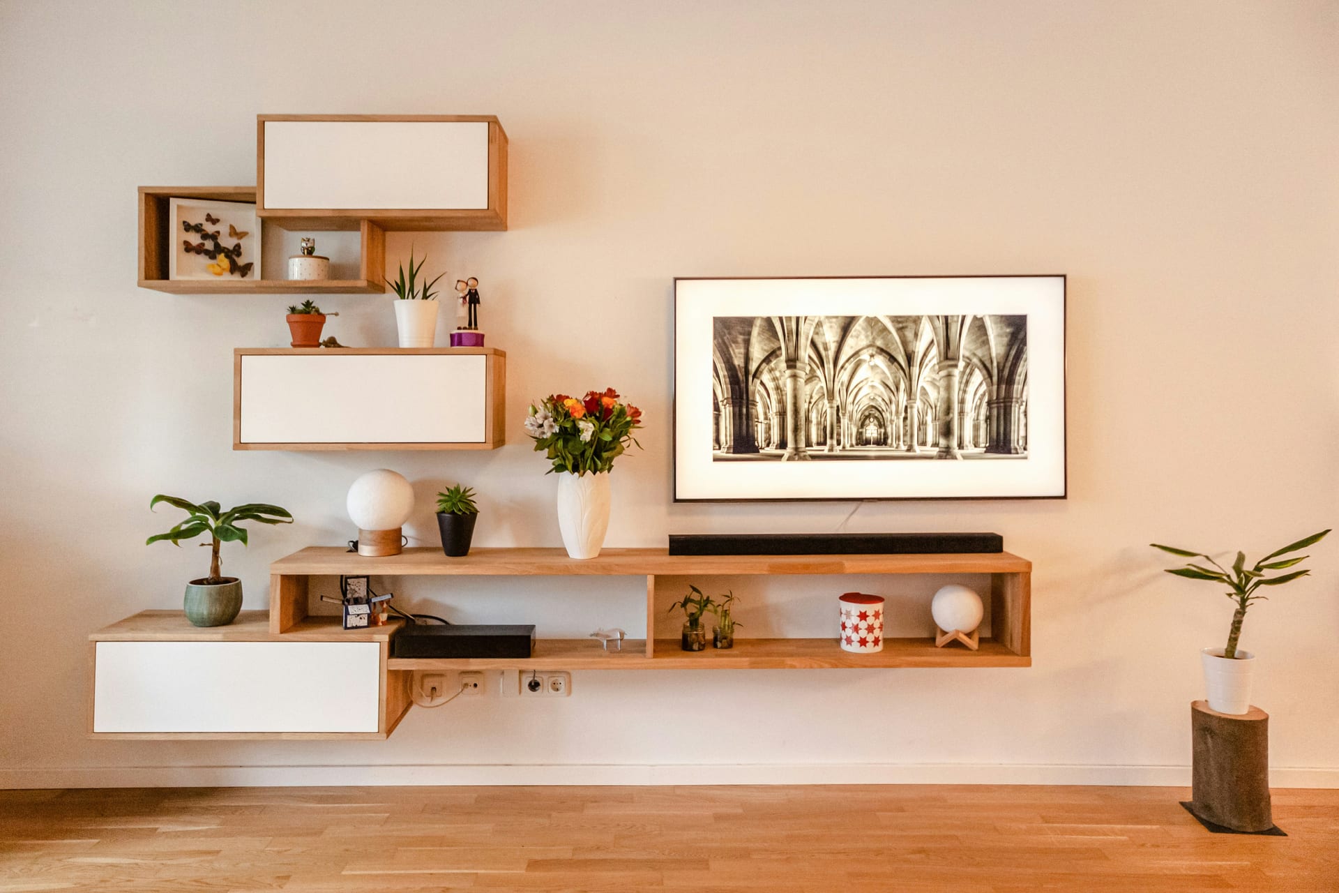 A dusted shelving unit with carefully arranged objects