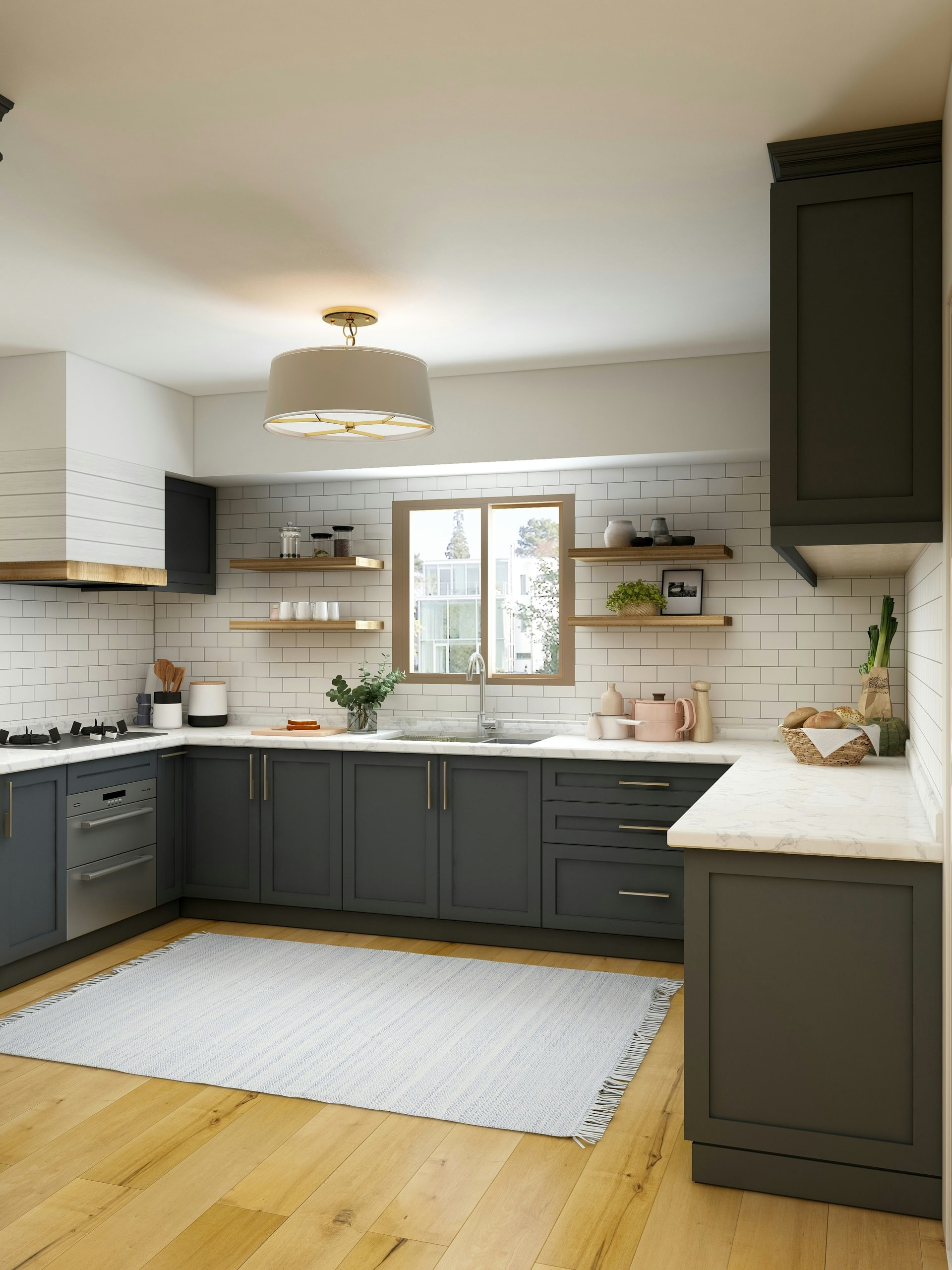 A spotless modern kitchen with grey cabinetry and clear worktops, lit by natural daylight
